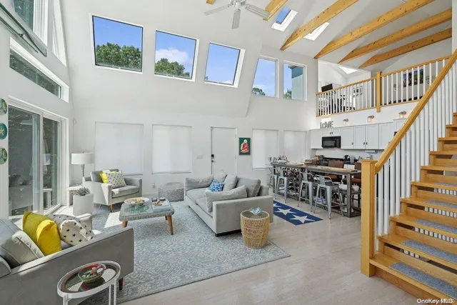 a living room with furniture and a book shelf