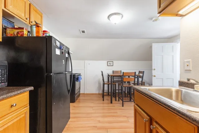 a kitchen with stainless steel appliances granite countertop a refrigerator and a sink