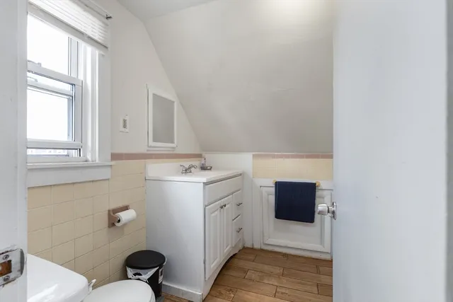 a bathroom with a sink a toilet and vanity
