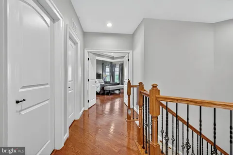a view of a hallway with a livingroom and a chandelier