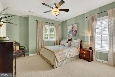 a bedroom with a bed dresser and a window