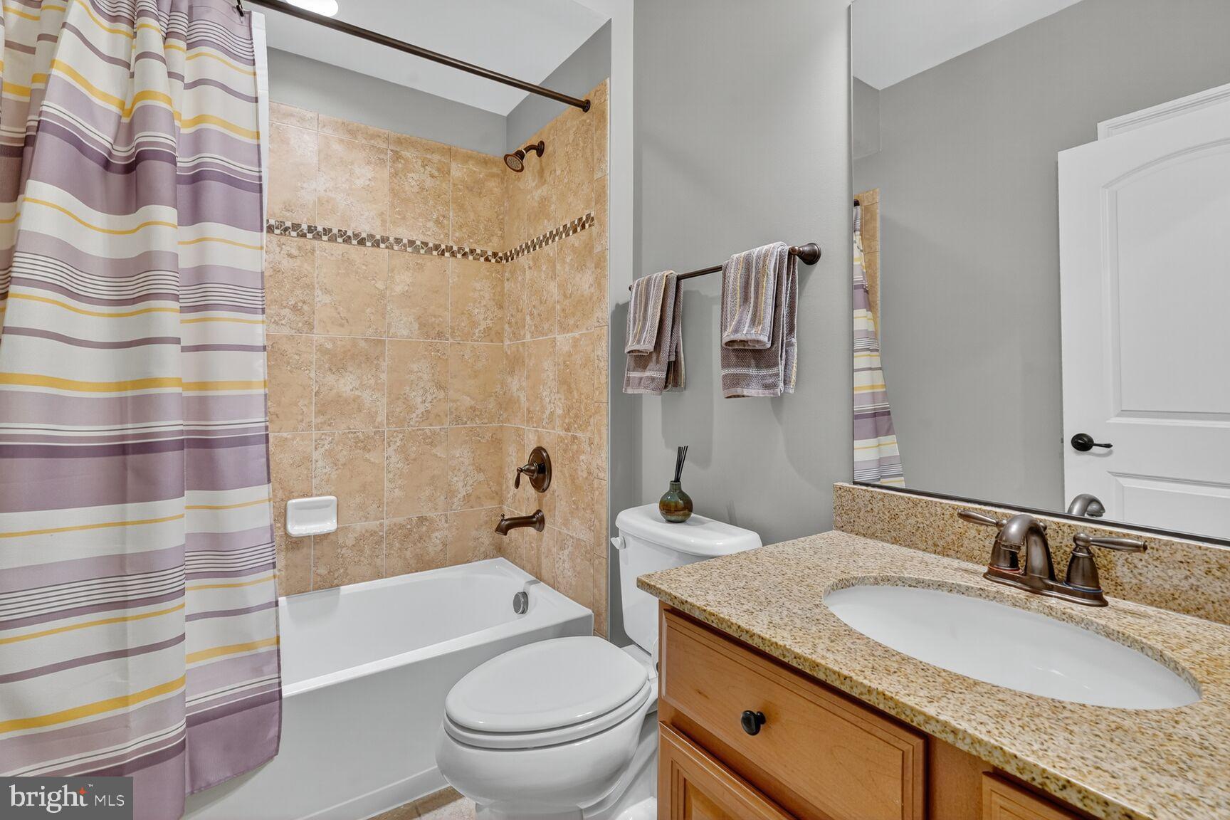 3206 Hatcher Street Alexandria, VA 22303 - Photo 38 of 49 a bathroom with a granite countertop sink toilet mirror and shower