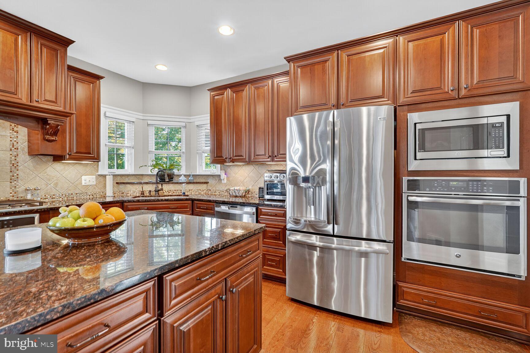 3206 Hatcher Street Alexandria, VA 22303 - Photo 9 of 49 a kitchen with granite countertop stainless steel appliances a refrigerator stove top oven and sink