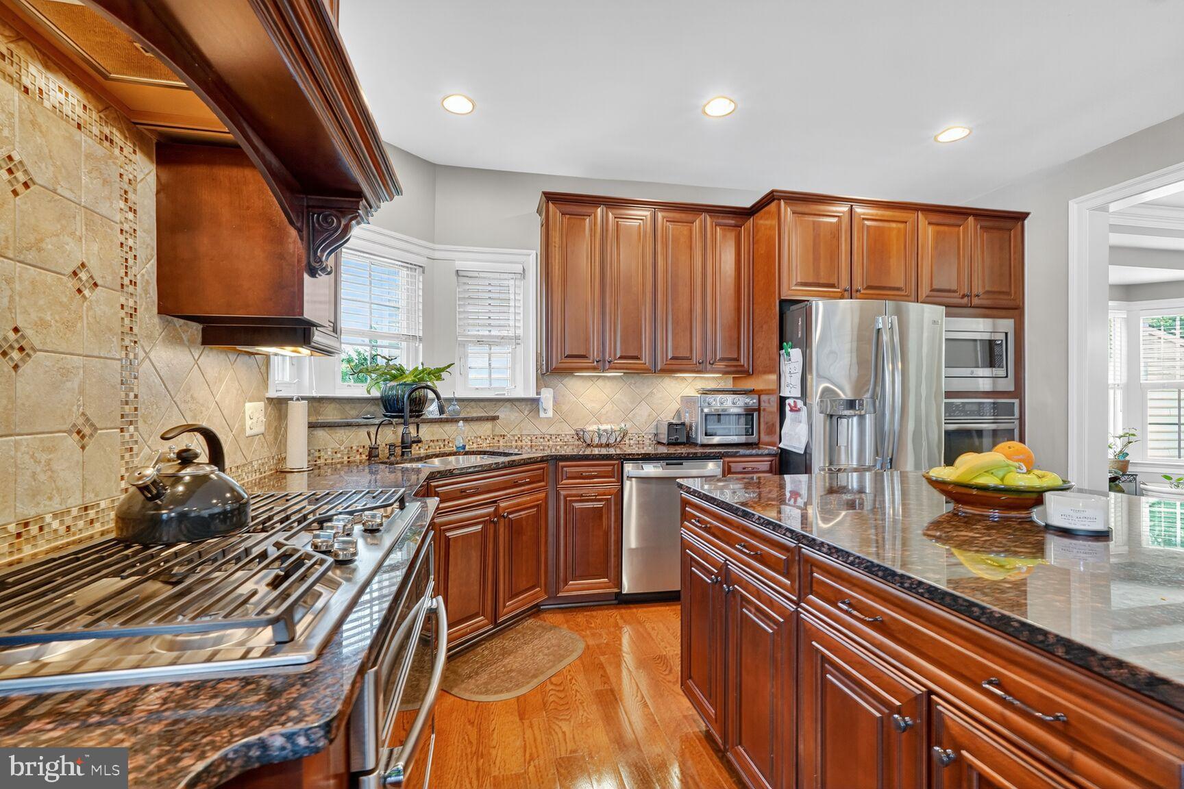 3206 Hatcher Street Alexandria, VA 22303 - Photo 10 of 49 a kitchen with stainless steel appliances granite countertop a sink stove and refrigerator