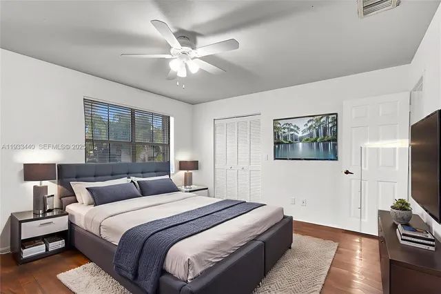 a bedroom with a large bed and a chandelier