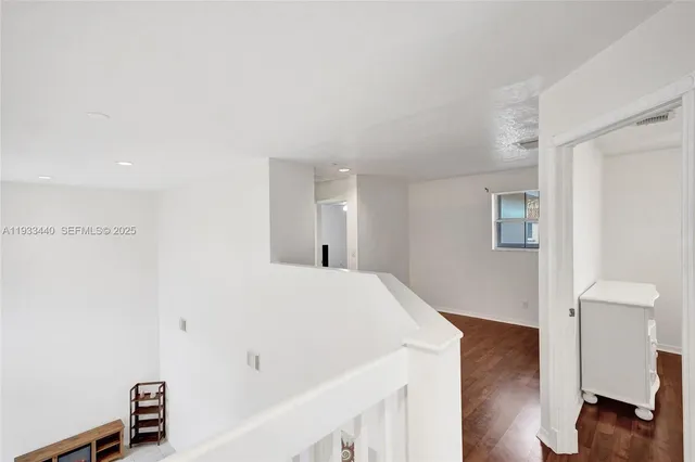 a view of a workspace with furniture and wooden floor
