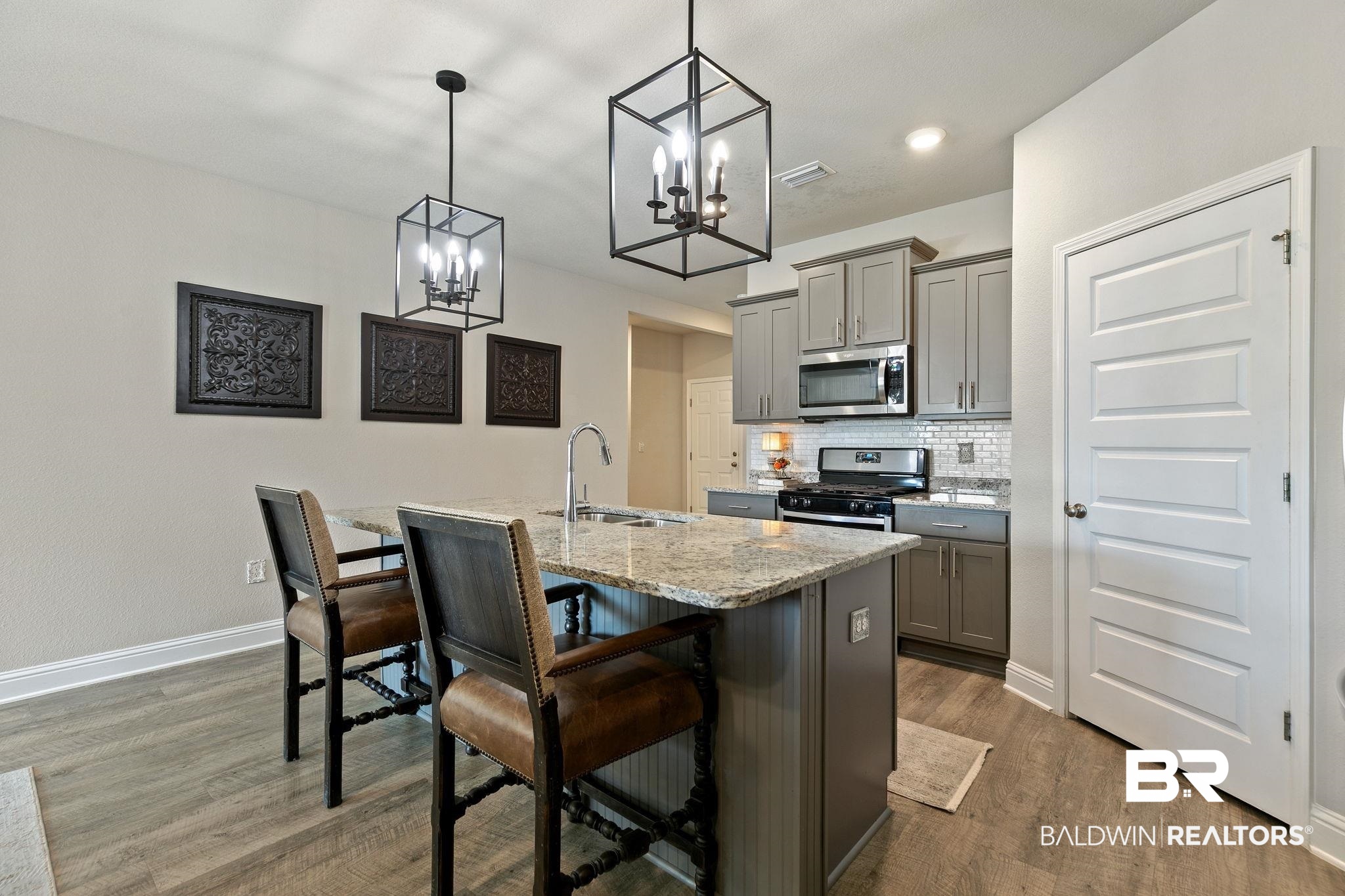 31650 Memphis Loop Daphne, AL 36527 - Photo 11 of 68 Kitchen with gray cabinetry, tasteful backsplash, light stone counters, a breakfast bar area, and stainless steel appliances