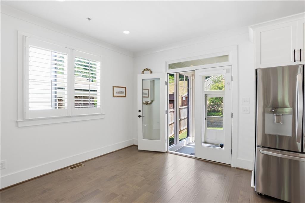 138 Rigby Street Northeast Marietta, GA 30060 - Photo 21 of 39 a view of an empty room with a window and wooden floor