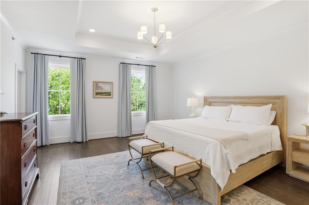 138 Rigby Street Northeast Marietta, GA 30060 - Photo 23 of 39 a spacious bedroom with a bed and a chandelier