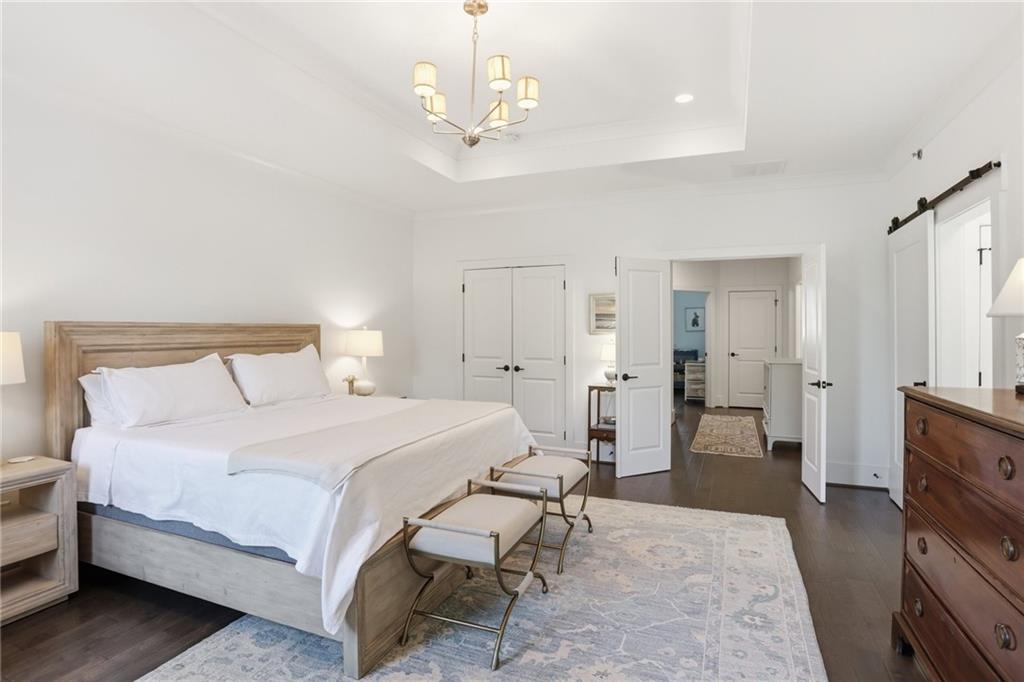 138 Rigby Street Northeast Marietta, GA 30060 - Photo 24 of 39 a bedroom with a bed and a chandelier