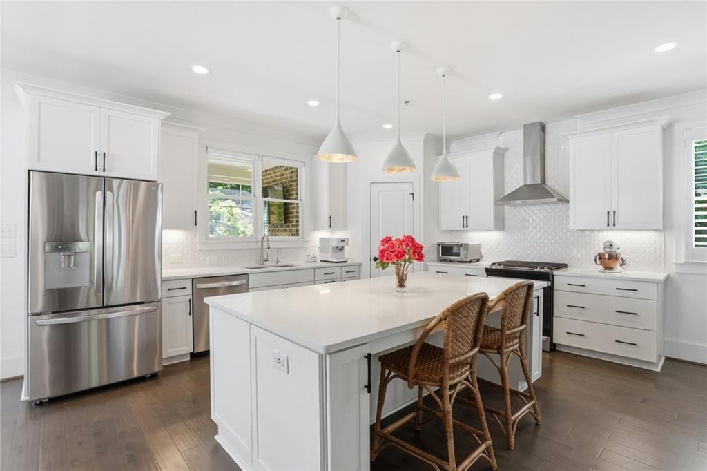 138 Rigby Street Northeast Marietta, GA 30060 - Photo 6 of 39 a kitchen with white cabinets and stainless steel appliances