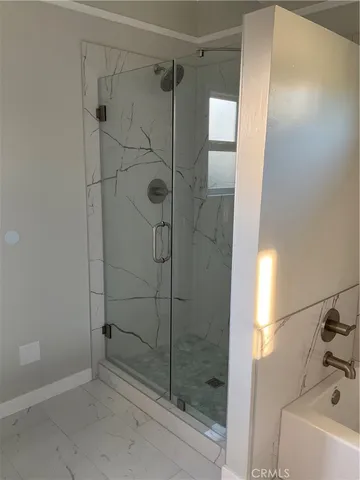 a bathroom with a shower and a sink