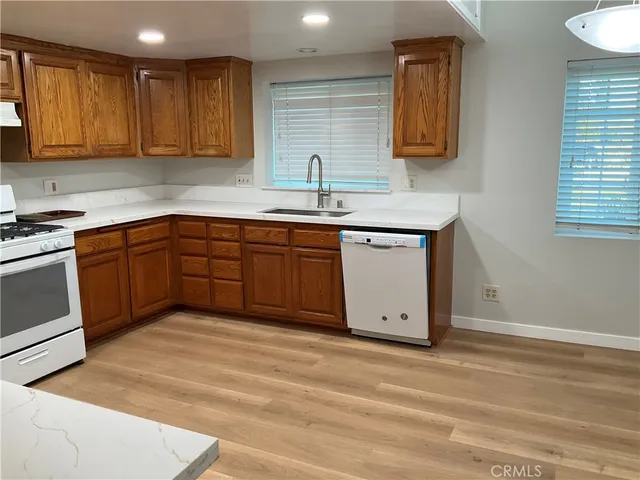 a kitchen with stainless steel appliances granite countertop a sink and cabinets