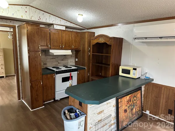 a kitchen with stainless steel appliances granite countertop a refrigerator a sink and wooden cabinets