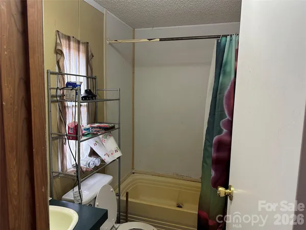 a bathroom with a toilet and a mirror