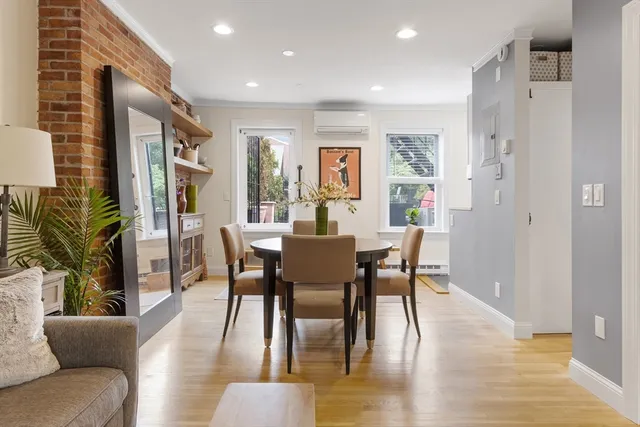 a view of a dining room with furniture window and wooden floor