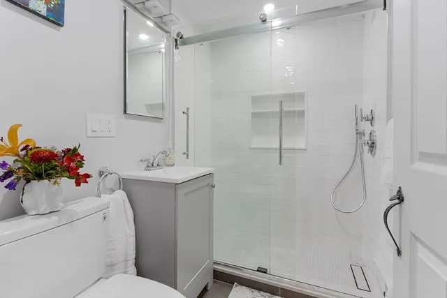 a bathroom with a sink mirror and a shower