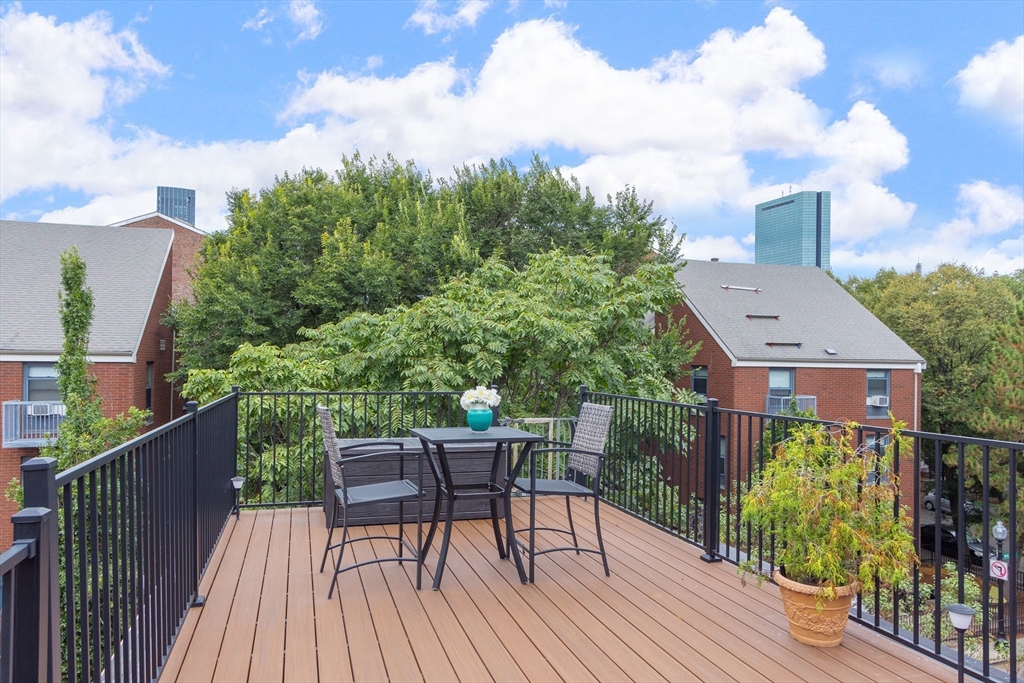 431 Shawmut Avenue, Unit PH Boston, MA 02118 - Photo 18 of 27 a view of a chairs and table on the deck