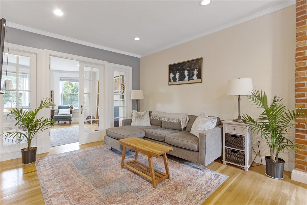 431 Shawmut Avenue, Unit PH Boston, MA 02118 - Photo 2 of 27 a living room with furniture potted plant and a fireplace