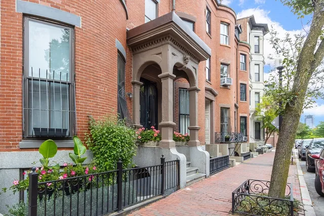 a front view of a house with a cars