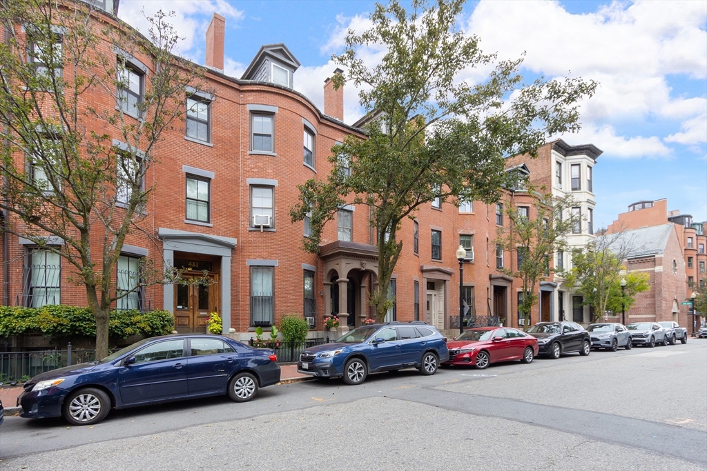 431 Shawmut Avenue, Unit PH Boston, MA 02118 - Photo 23 of 27 a car parked in front of a building