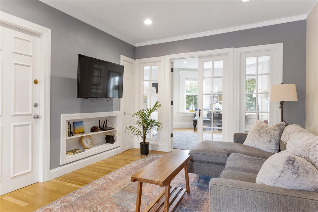 431 Shawmut Avenue, Unit PH Boston, MA 02118 - Photo 3 of 27 a living room with furniture a flat screen tv and a fireplace