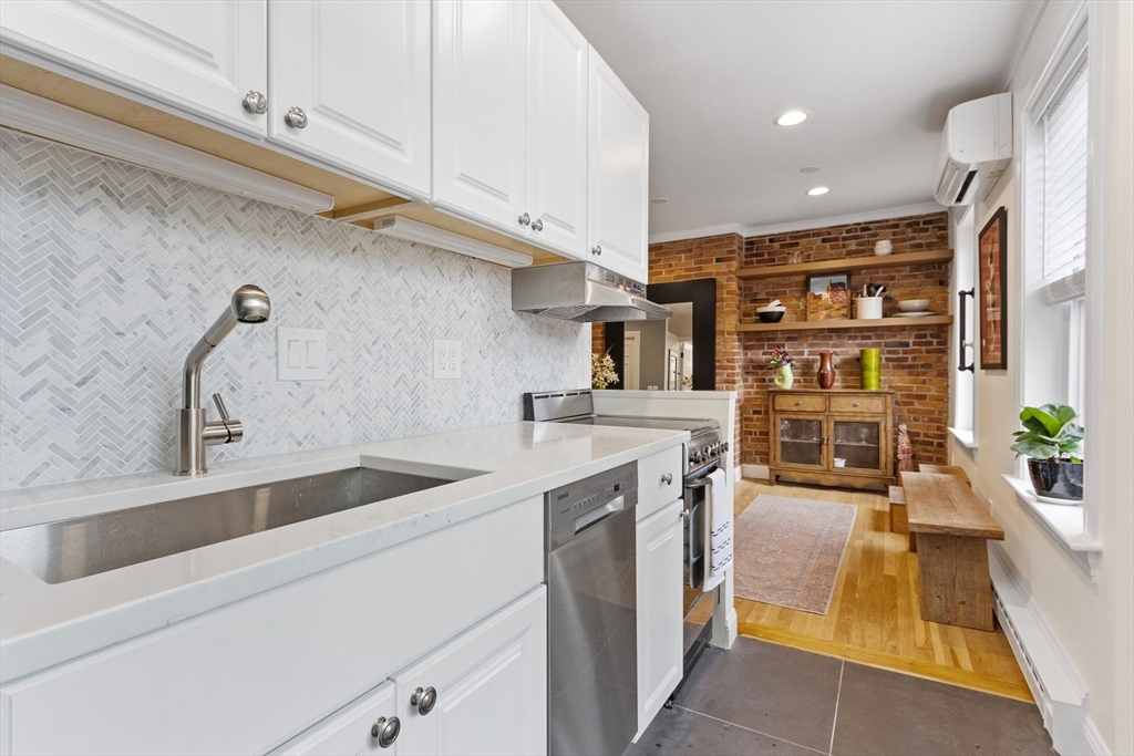 431 Shawmut Avenue, Unit PH Boston, MA 02118 - Photo 7 of 27 a kitchen with stainless steel appliances granite countertop a sink and cabinets