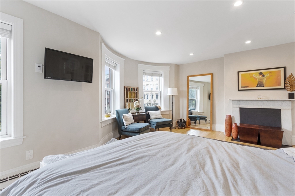 431 Shawmut Avenue, Unit PH Boston, MA 02118 - Photo 10 of 27 a bedroom with a bed and a television