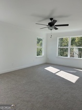 517 Principal Meridian Drive, Unit 22 Dallas, GA 30132 - Photo 11 of 17 an empty room with windows and fan