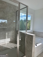 517 Principal Meridian Drive, Unit 22 Dallas, GA 30132 - Photo 13 of 17 a bathroom with a glass shower door