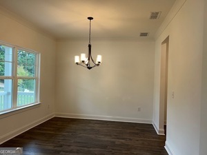 517 Principal Meridian Drive, Unit 22 Dallas, GA 30132 - Photo 4 of 17 a view of empty room with wooden floor and windows
