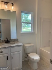 517 Principal Meridian Drive, Unit 22 Dallas, GA 30132 - Photo 8 of 17 a bathroom with a granite countertop toilet a sink and a bathtub