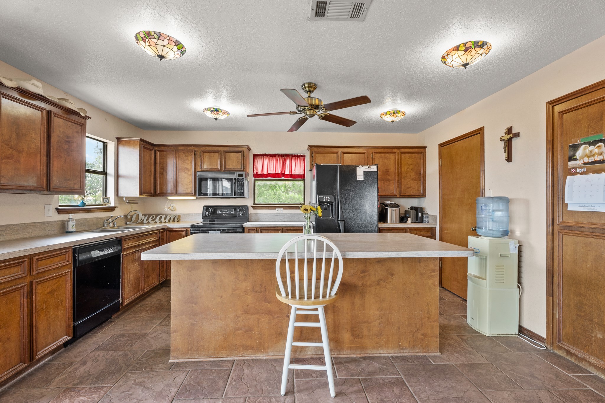 13803 Norris Road Rosharon, TX 77583 - Photo 5 of 20 a kitchen with stainless steel appliances granite countertop a stove refrigerator a sink dishwasher a dining table and chairs with wooden floor
