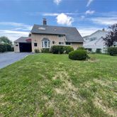 a view of a house with backyard and garden