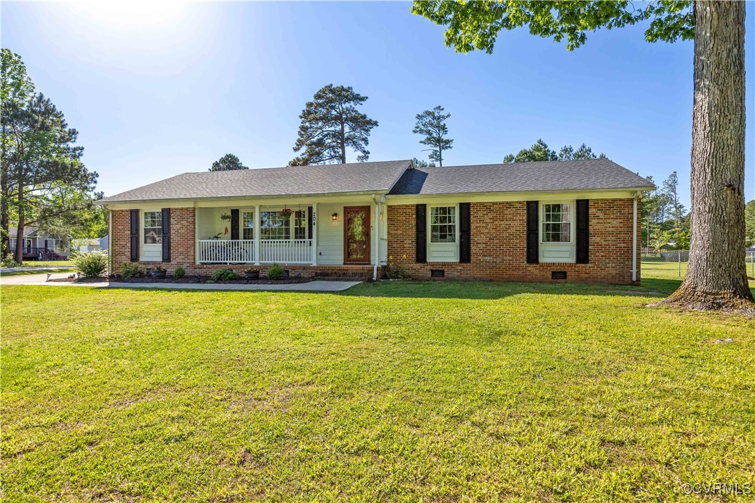 Ranch-style home with a shingled roof, brick sidin