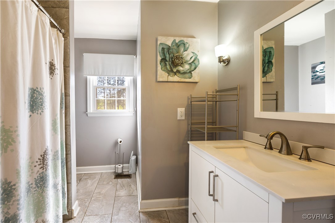 204 Pine Street Jarratt, VA 23867 - Photo 21 of 25 Bathroom with baseboards, a shower with shower cur