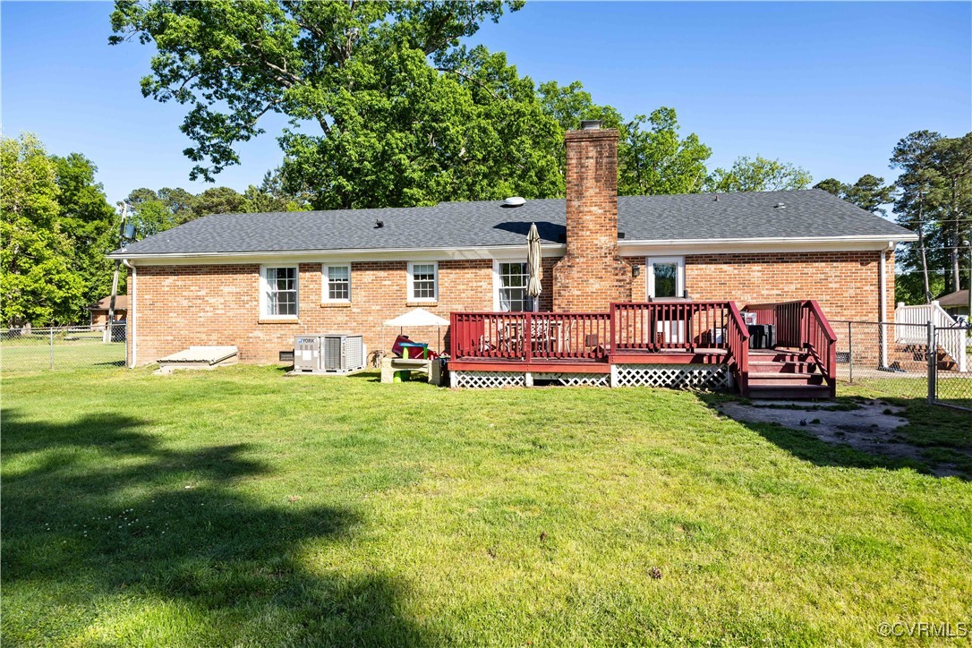204 Pine Street Jarratt, VA 23867 - Photo 22 of 25 Back of house featuring fence, brick siding, a dec