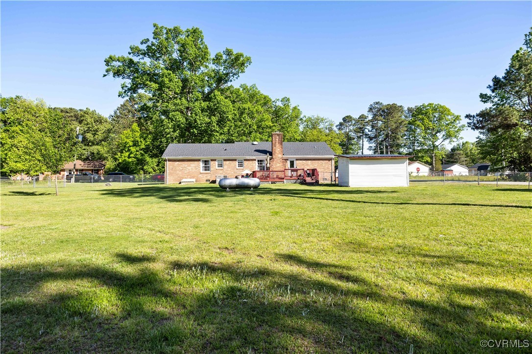204 Pine Street Jarratt, VA 23867 - Photo 24 of 25 Rear view of house with fence, brick siding, a dec