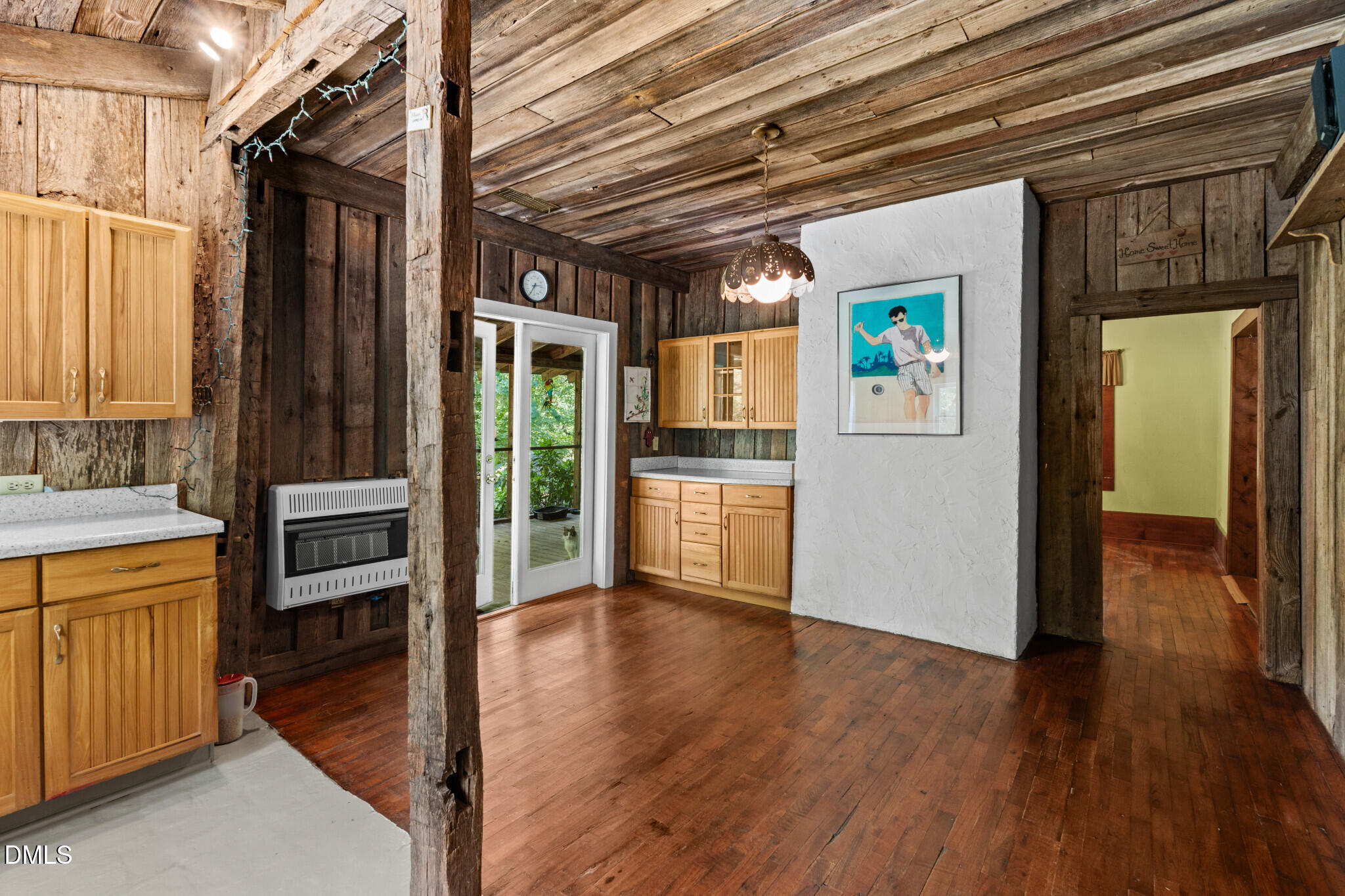 3415 Mt Willing Road Efland, NC 27243 - Photo 10 of 36 a view of a hallway with wooden floor and a kitchen