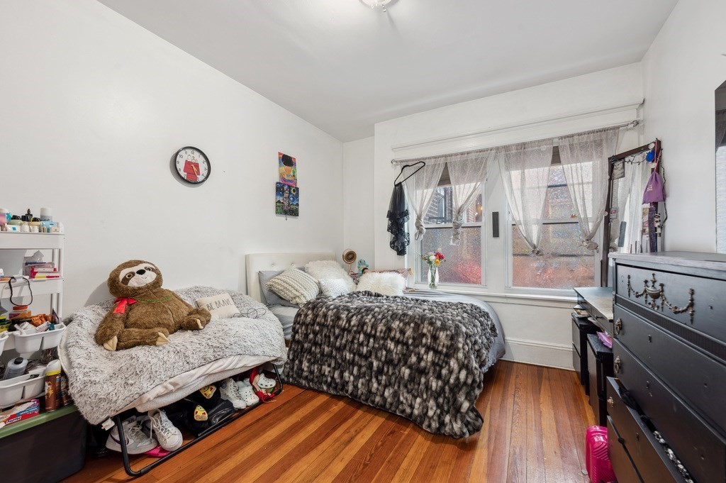 221 Shurtleff Street, Unit 1 Chelsea, MA 02150 - Photo 11 of 16 a bedroom with furniture and a window