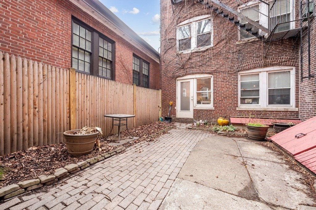 221 Shurtleff Street, Unit 1 Chelsea, MA 02150 - Photo 14 of 16 a backyard of a house with a table and chairs