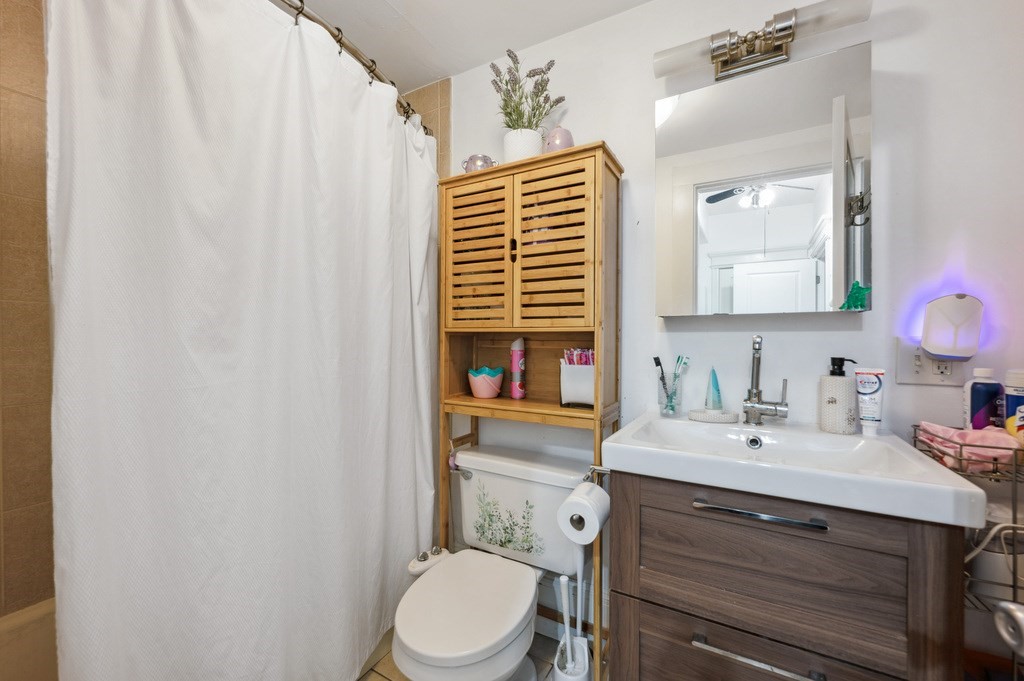 221 Shurtleff Street, Unit 1 Chelsea, MA 02150 - Photo 10 of 16 a bathroom with a sink a toilet and mirror
