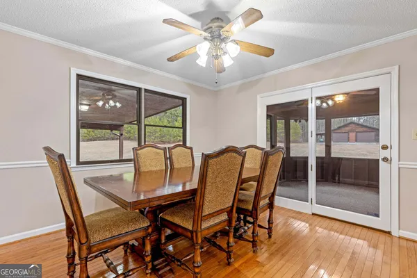 a living room with furniture and floor to ceiling window