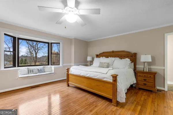 a bedroom with a bed dresser and a window