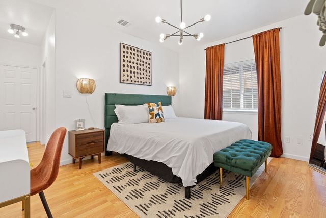 a bedroom with a bed and a chandelier