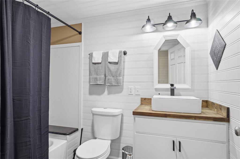 10 Ss Cooper, TX 75432 - Photo 18 of 40 a bathroom with a toilet sink and mirror