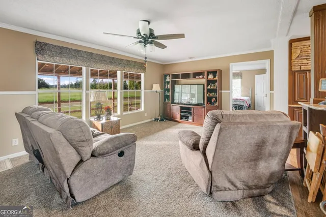 a living room with furniture and large windows