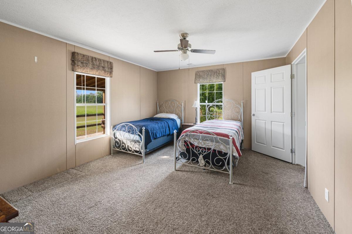 82 Harris Road Baxley, GA 31513 - Photo 16 of 23 a spacious bedroom with a bed and a window