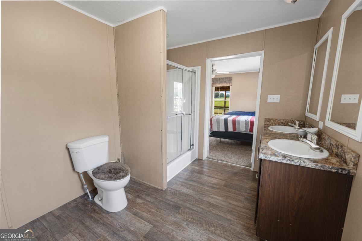 82 Harris Road Baxley, GA 31513 - Photo 18 of 23 a bathroom with a granite countertop sink and a mirror