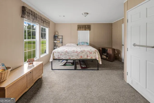 a bed room with a bed and a large window